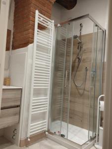 a shower with a glass enclosure in a bathroom at Casa Erica in Cortona