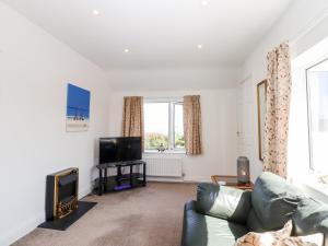 a living room with a couch and a flat screen tv at Bay Tor in Dover