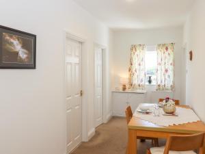 a dining room with a table and a window at Bay Tor in Dover