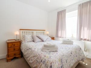 a bedroom with a bed with two towels on it at Bay Tor in Dover