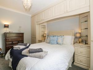 a bedroom with a large white bed with two towels on it at Melita in Langport