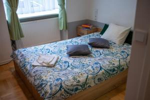 a bedroom with a bed with two pillows on it at Lukas Guest Rooms in Kraków +24 photos