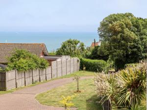 a backyard with a fence and a yard with plants at Bay Tor in Dover