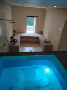 a bathroom with a swimming pool and a tub at Casa Alberto Santos in San Miguel de Abona