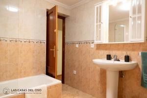 a bathroom with a sink and a bath tub and a sink at Casa Ronderos - Las Casas del Oso in Rodiles +35 photos