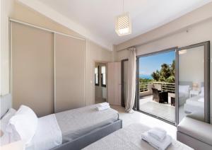 a bedroom with a bed and a view of the ocean at Villa Sofia in Póndi