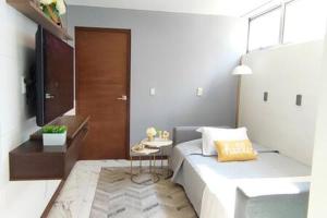 ein Schlafzimmer mit einem Bett und einem kleinen Tisch in der Unterkunft Siqueiros Maia Home - Lujoso apto en Polanco cerca de Antara 3BR in Mexiko-Stadt