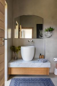 a bathroom with a large sink and a mirror at The One in Knysna