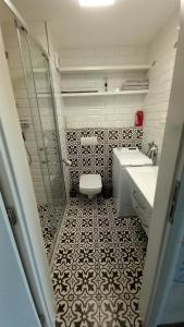 a bathroom with a toilet and a sink and a shower at Mountain View Studio Apartment in Poprad +16 photos