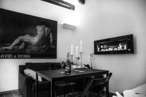 a dining room with a table and a painting on the wall at Campo De Fiori Apartment in Rome