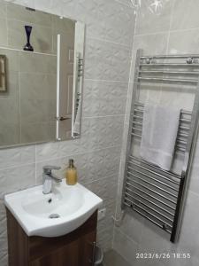 a white bathroom with a sink and a mirror at Nire Valley Cottage 