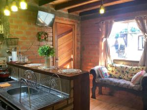 a kitchen with a sink and a window at Pousada Tarumã challes 01 in Bonito