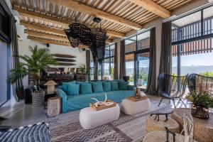a living room with a blue couch and some chairs at The One in Knysna