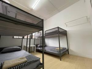 a bedroom with two bunk beds in a room at Homestay Kuching BBQ and Kitchen in Kuching