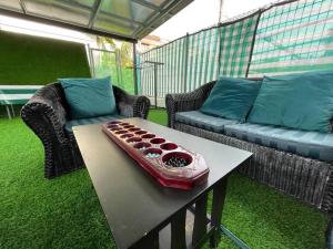 a living room with a couch and a table at Homestay Kuching BBQ and Kitchen in Kuching
