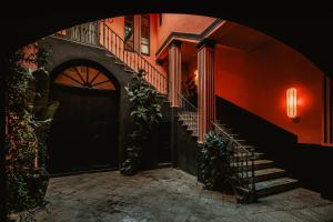 a staircase leading to a building with a black door at Palazzo Flora in Gallipoli