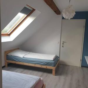 a small bedroom with a bed and a window at Obere Dorfstraße in Wolfsburg