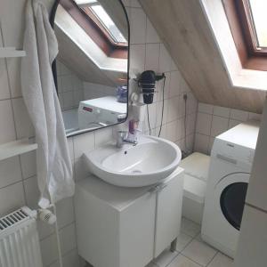 a bathroom with a sink and a washing machine at Obere Dorfstraße in Wolfsburg