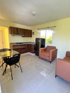 a kitchen with a couch and a table and chairs at Hotel La Playa in Santa Cruz de Barahona
