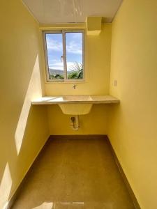 a bathroom with a sink and a window at Hotel La Playa in Santa Cruz de Barahona