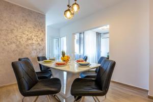 a dining room with a table and four chairs at Apolon 2BDR apartment with balcony in Zadar