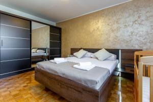 a bedroom with a large bed with two pillows on it at Apolon 2BDR apartment with balcony in Zadar