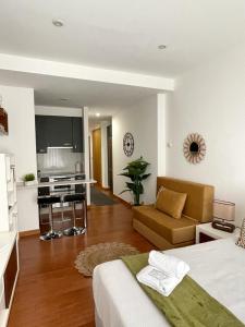 a bedroom with a bed and a living room with a desk at CarreraHouses Canela in Vigo