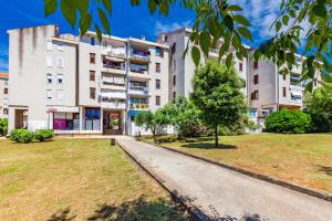 an apartment building with a park in front of it at Apolon 2BDR apartment with balcony in Zadar