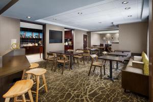 a restaurant with tables and chairs in a room at SpringHill Suites Manchester-Boston Regional Airport in Manchester