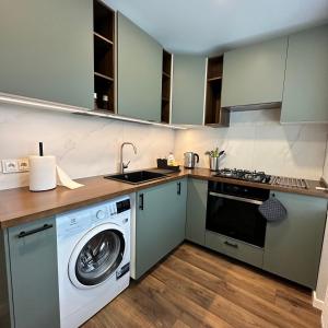 a kitchen with a washing machine and a washer at Cozy Apartment Kazlų Rūda in Kazlų Rūda