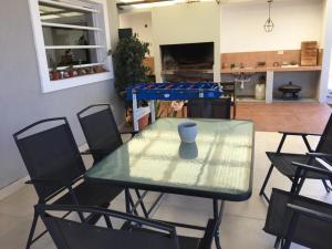 a glass table and chairs in a living room at Balcon de los Andes in Salta