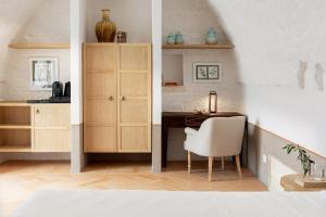 a kitchen with a desk and a chair in a room at Masseria Auraterrae in Polignano a Mare