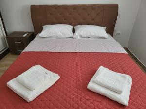 un letto con due asciugamani bianchi sopra di Novi Relax apartment a Herceg-Novi