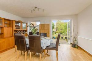 a dining room with a table and chairs at Spacious 5 Bedroom 11 Guest Family House in Horsham in Roffey