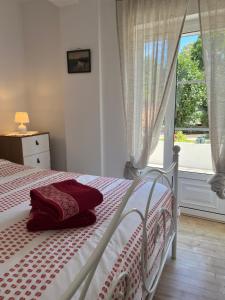a bedroom with a white bed with a window at Casa das Pomegranates in Ílhavo