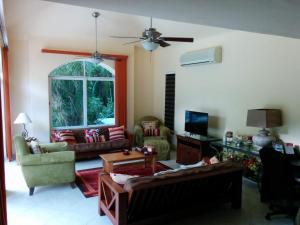 a living room filled with furniture and a window at Casa Beard, Spacious Guest House with High Speed WiFi & Pool. in Playa del Carmen