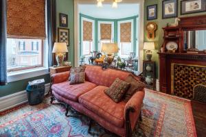 a living room with a couch and a fireplace at The Dolon House Bed & Breakfast! in Jim Thorpe