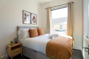 a bedroom with a large bed and a window at Air Host and Stay - Dacy House, sleeps 7, free parking minutes from city centre in Liverpool
