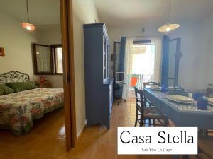 a room with a bed and a table in a room at Casa Stella San Vito Lo Capo in San Vito lo Capo