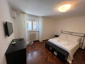 a bedroom with a bed and a television in it at CORTILET in Fasano