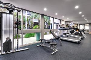 a gym with two treadmills and two exercise bikes at Atrium Hotel Orange County in Irvine