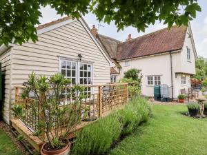 a house with a wooden fence and a yard at Rector's Retreat in Ipswich