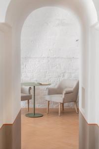 a living room with two chairs and a table at Masseria Auraterrae in Polignano a Mare