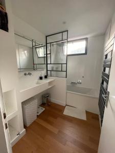 łazienka z wanną, umywalką i lustrem w obiekcie Maison moderne Avignon 6 pers w Awinionie