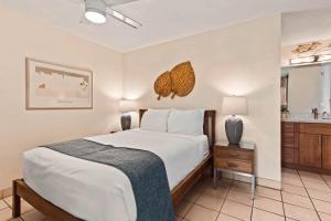 a bedroom with a large bed and a bathroom at Paki Maui 303 in Kahana +21 photos