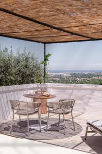 two chairs and a table on a patio at Masseria Auraterrae in Polignano a Mare