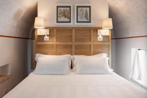 a bedroom with a bed with white pillows at Masseria Auraterrae in Polignano a Mare