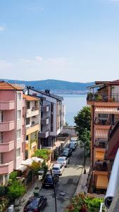a city street with buildings and cars parked on the street at Вила Далия - Несебър in Nesebar