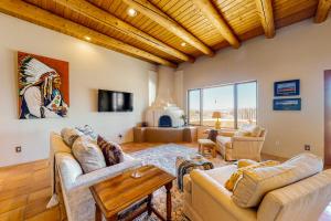 a living room with two couches and a table at Casa Luna in Ranchos de Taos