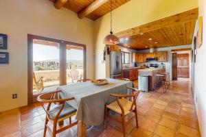 a kitchen and dining room with a table and chairs at Casa Luna in Ranchos de Taos
